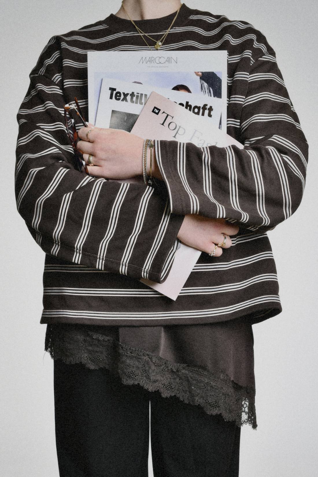 Merle Sophie Heidbrink mit Ausgaben der TextilWirtschaft und weiterer Fachpresse